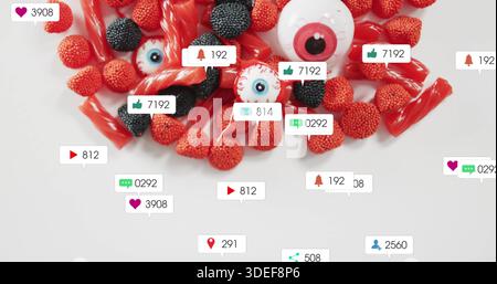 Displaying red licorice nonpareil gummies black gumdrops white eyeballs with badges on table Stock Photo