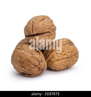 Walnuts in their shells stacked together, showing natural textures and hard exteriors. Isolated on white background. Stock Photo