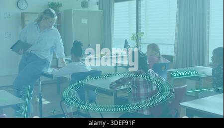 Leaning woman teacher holding tablet and engaging class in classroom with circular HUD, copy space Stock Photo