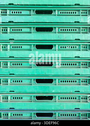 High angle view of green industrial plastic crates stacked in a factory for storage, logistics, and organized equipment management. Stock Photo