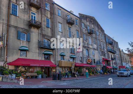 Savannah, Georgia, USA - October 22, 2025: Rows of old Cotton warehouses line a cobblestone street in historic downtown district. Stock Photo