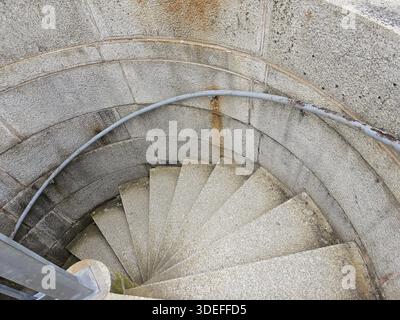 Spiral staircase with stone stairs looking down view Stock Photo
