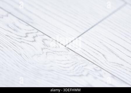 Light wood floor detail close-up. Light wooden floor close-up with visible grain and seams, modern interior texture background with copy space. Stock Photo