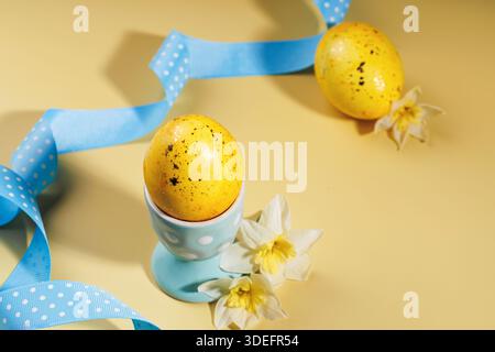 Easter table setting with decorated eggs, ribbon and flowers Stock Photo