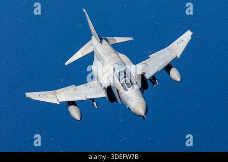 The photograph depicts a Hellenic Air Force McDonnell Douglas F-4E Phantom II performing an air-to-air display at Athens Flying Week 2025. The F-4E is powered by two General Electric J79-GE-17 turbojet engines and features a twin-seat cockpit and variable mission capability. The image highlights the aircraft’s external stores stations, swept wing design, and high-speed interceptor profile, representing a key combat aircraft in Greek Air Force service. Stock Photo