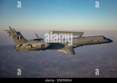 The image depicts a Hellenic Air Force Embraer EMB-145H AEW&C aircraft, registration 729, serial 145729, of 380 Mira Squadron during Athens Flying Week 2025. Equipped with the Erieye radar system, this twin-turbofan aircraft provides airborne early warning and control capabilities. The photograph highlights air-to-air operation, high-mounted radar, fuselage configuration, cockpit layout, and surveillance mission readiness, demonstrating the operational role of AEW&C aircraft in Greek Air Force air defense and command operations. Stock Photo