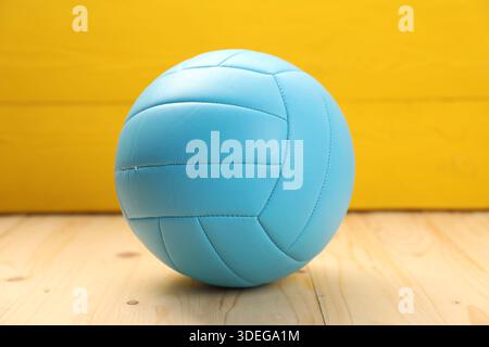 One bright volleyball ball on wooden table Stock Photo