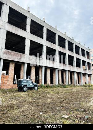 Large abandoned unfinished brick building skyscraper and big yellow ...