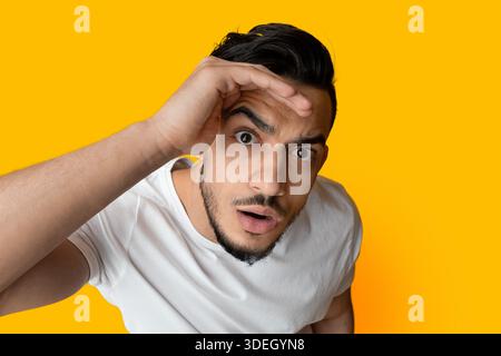 Top view of surprised middle eastern guy looking at camera Stock Photo