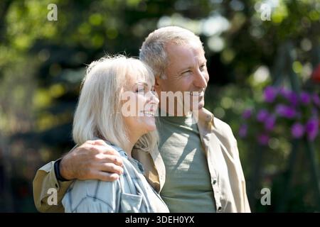 Happy loving senior spouses embracing and enjoying warm spring days, spending time together outdoors Stock Photo