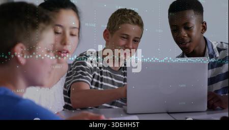 Collaborating students in striped shirts typing notes at study table with laptop and data overlays Stock Photo