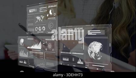 Displaying holographic dashboards floating over office table with tablet, stylus and team in suits Stock Photo