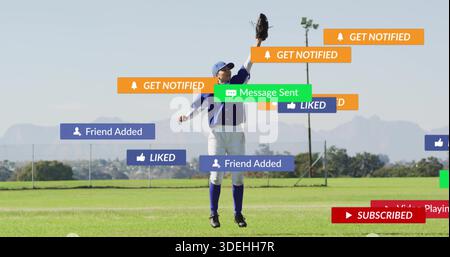 Leaping player in blue baseball kit and cap, reaching with glove in outfield, with social tags Stock Photo