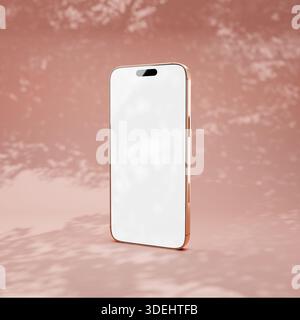 Pink phone on pastel background with a shadow tree leaves. Blank screen for mockup or presentation. Stock Photo
