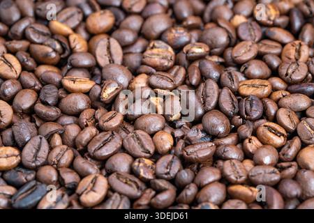 Dark roasted bean closeup image, Highquality espresso beans for promotional display, Detailed shot of glossy coffee beans suitable for advertising Stock Photo