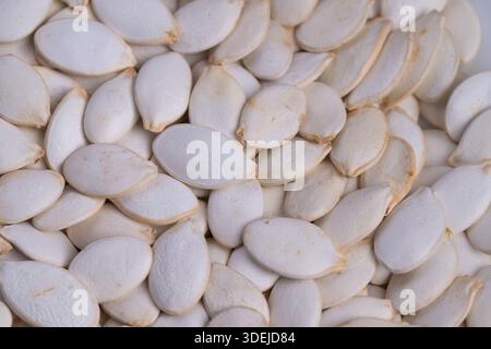 Isolated pumpkin seeds on bright white background, Clean and detailed image showcasing pumpkin seeds in professional studio setting for online retail Stock Photo