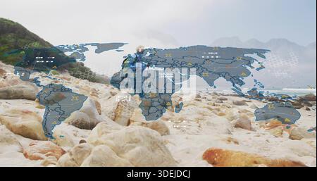 Standing woman hiker wearing technical jacket and backpack on rocky shore with world map overlay Stock Photo