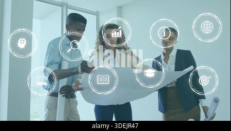 Studying three staff reviewing blueprint in bright office, in suits holding plans and hologram Stock Photo