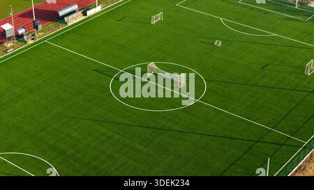 Wide aerial view of football training field with small goal on synthetic grass surface Stock Photo