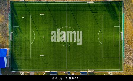 Top down aerial view of football field with artificial turf, ideal for sports analysis and background use Stock Photo