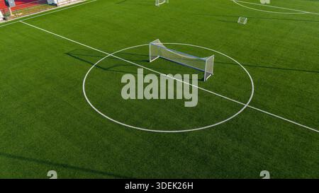 Minimal aerial view of football training goal on artificial turf with clean green background Stock Photo