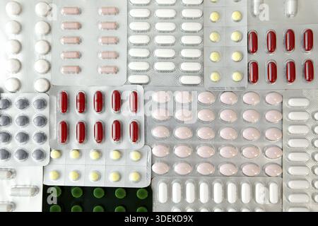 Heap of colored assorted medicine pills, tablets and Capsules. Antiviral capsule, pills in plastic blister package. Medication pill for prevention and Stock Photo
