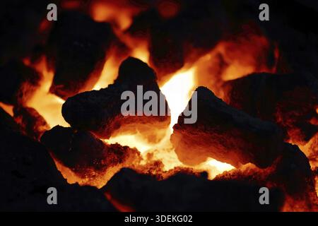 Textured smoldering charcoal surface in a fireplace Stock Photo