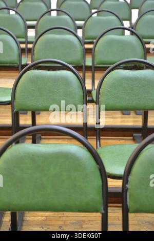 Rows of comfortable metal chairs stand in the lecture hall Stock Photo