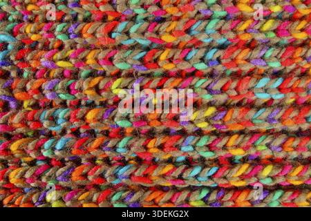 Pattern fabric wool Background. relax autumn and winter season arrangement flat lay style. knitting wool scarf. knitted cloth from multi-colored woole Stock Photo
