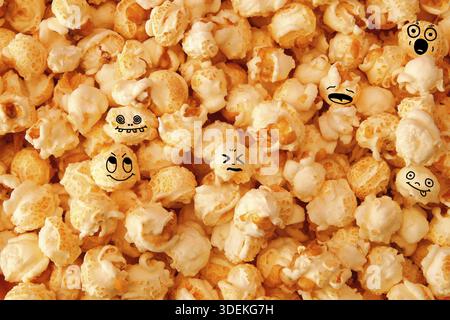 Hoax symbol. funny smiling popcorn background. detailed close-up of Scattered caramel popcorn, texture background. Full frame Stock Photo