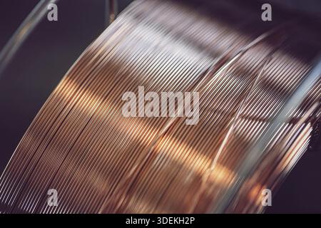 Working atmosphere in an old welding shop with a focus on the coil of welding wire for automatic welding in shielding gases Stock Photo
