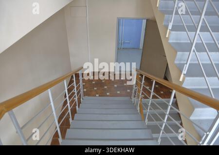 Staircase between floors in an empty office building Stock Photo