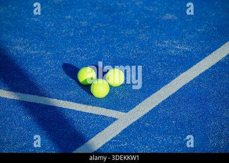 Yellow balls on blue ground with hard shadows. The Concept of Sunny Day. Stock Photo