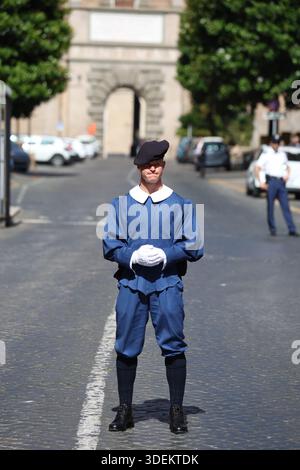 Vatican Swiss Guard in Traditional Blue Duty Uniform Standing at Attention on a Cobblestone Street Stock Photo