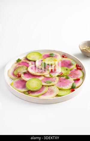 Sliced winter watermelon radish on white plate Stock Photo