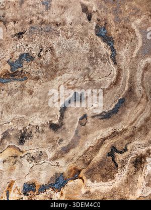 Abstract marble texture with blue and gold veins on beige stone background. Natural surface features intricate swirling patterns Wallpaper aesthetic Stock Photo