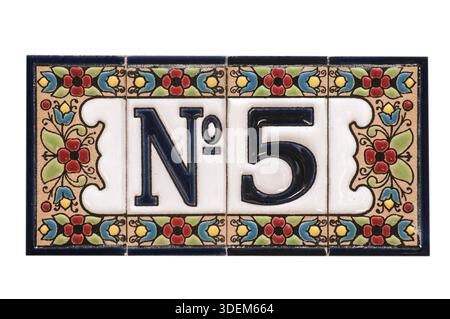 Weathered grunge square faience enameled decorated plate of number of street address with number 5 closeup isolated on white background Stock Photo