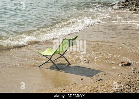 Folding chair on sea beach closeup in sunny summer day Stock Photo