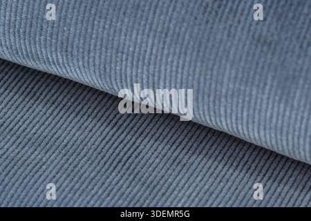 Blue textured corduroy fabric patterns closeup as textile background Stock Photo