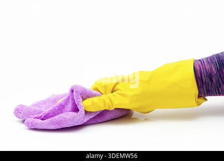 Microfiber cleaning cloth in woman hand. Surface home cleaning wearing medical yellow gloves. Sanitize, cleaning surfaces prevention in hospitals and Stock Photo