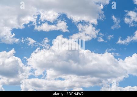 Puffy white clouds in the summer sky. Stock Photo