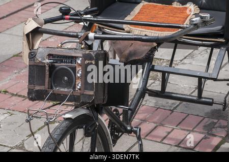 Vintage radio mounted on old fashioned three wheel bike Stock Photo