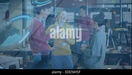 Talking woman in yellow sweater wearing lanyard holding coffee cup at tech hub with AR overlay Stock Photo