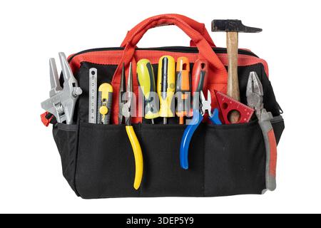 Red and black fabric tool bag holding an assortment of hand tools isolated on white background Stock Photo