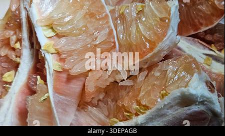 Extreme close-up macro of fresh pomelo citrus flesh showing large translucent segments and juicy texture.healthy nutrition, tropical fruit, fresh food Stock Photo
