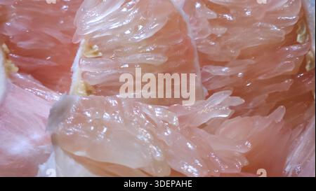 Extreme close-up macro of fresh pomelo citrus flesh showing large translucent segments and juicy texture.healthy nutrition, tropical fruit, fresh food Stock Photo