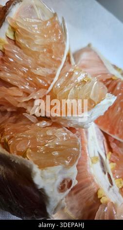 Extreme close-up macro of fresh pomelo citrus flesh showing large translucent segments and juicy texture.healthy nutrition, tropical fruit, fresh food Stock Photo