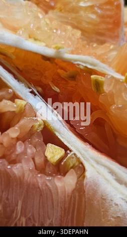Extreme close-up macro of fresh pomelo citrus flesh showing large translucent segments and juicy texture.healthy nutrition, tropical fruit, fresh food Stock Photo