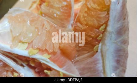 Extreme close-up macro of fresh pomelo citrus flesh showing large translucent segments and juicy texture.healthy nutrition, tropical fruit, fresh food Stock Photo