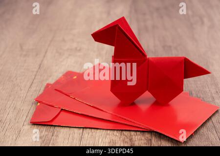 Horse origami on top of red envelope 2026 Year of the Horse concepts wood background Stock Photo